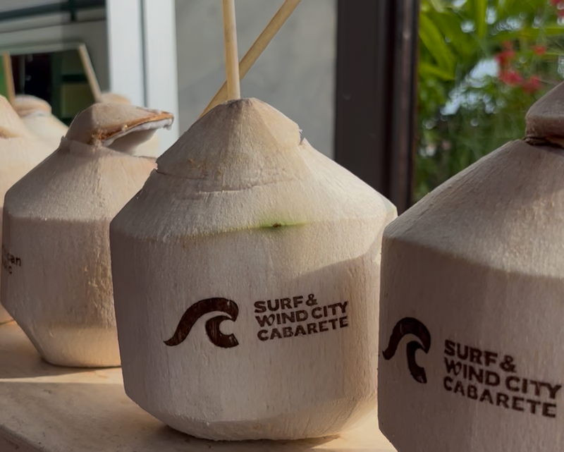 Branded coconut display for the Surf & Wind City Cabarete and Dominican Republic event, part of an immersive destination brand activation featuring Gavi Leveaux.