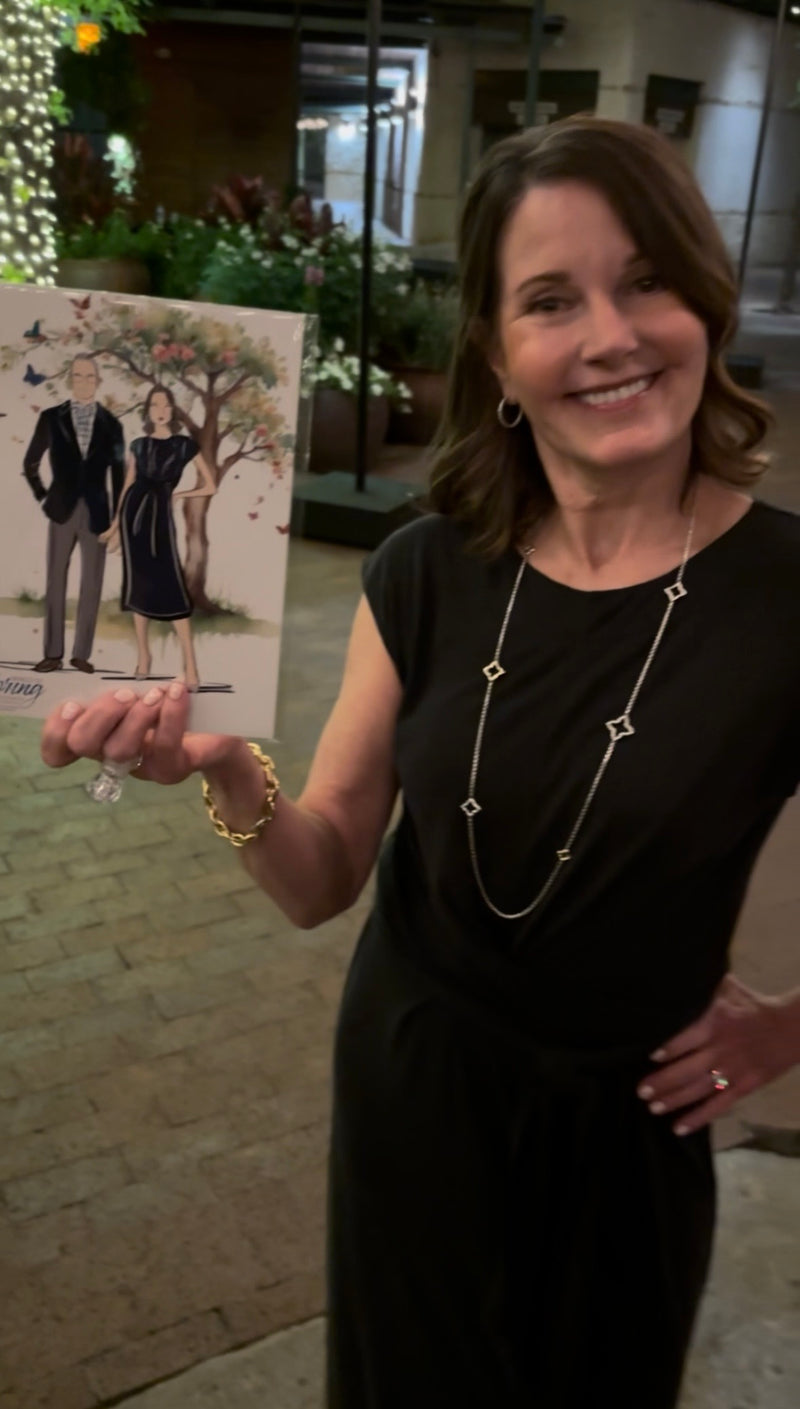 Guests celebrating with their personalized fashion illustration at the Literacy Achieves Wings of Spring Gala in Dallas