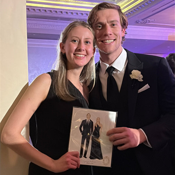 Wedding guest smiling while receiving a personalized 8x10 illustrated keepsake.