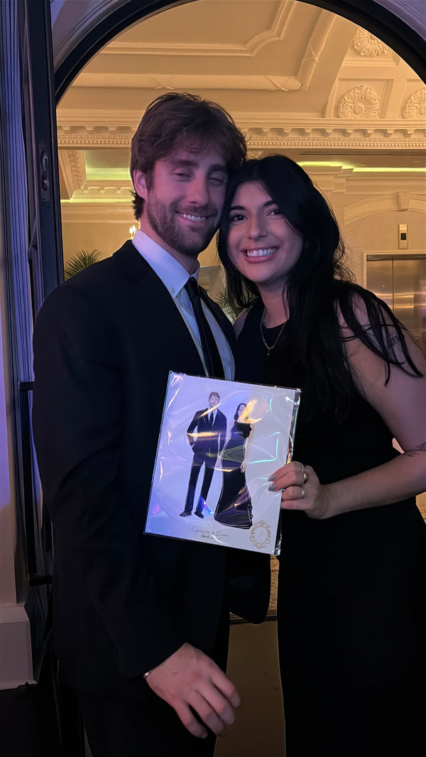 Guests enjoying live illustration entertainment during a wedding reception at Le Tesserae.
